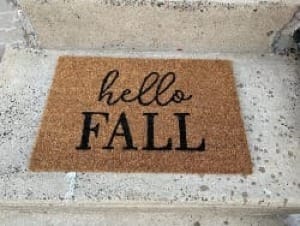 a doormat says "hello fall"