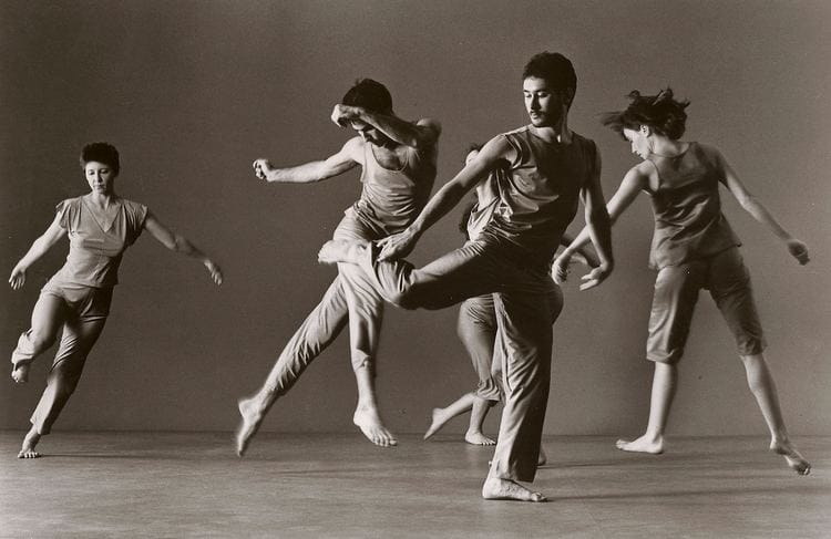 five dancers are pictured, they are each doing a different movement but it works together as a whole