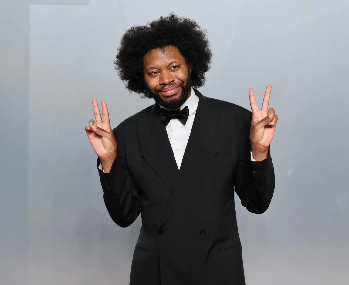 playwright Jeremy O. Harris looking dapper in a black tux and peace signs on both hands