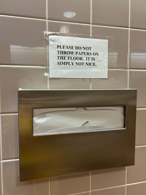restroom sign reads: please do not throw papers on the floor. it is simply not nice.